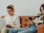 two teenagers using job apps on a phone and laptop