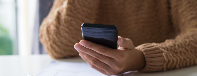 Close view of a woman taking a survey on her smartphone.