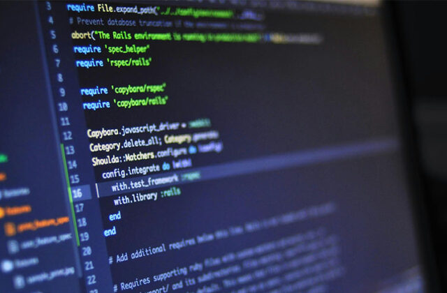 Monitor showing an IDE with code for a software engineering side hustle.