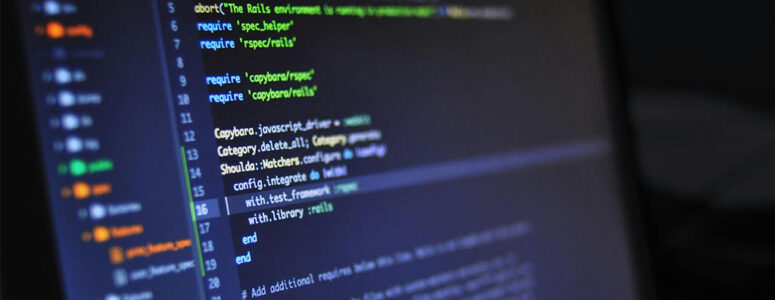 Monitor showing an IDE with code for a software engineering side hustle.