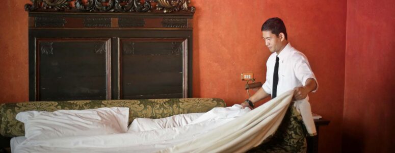 Shift worker cleaning a hotel room.