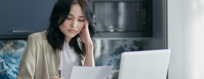 Independent worker frowning at a task she's partially outsourced to AI.