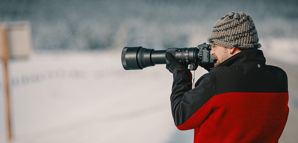 A photographer is taking landscape photos