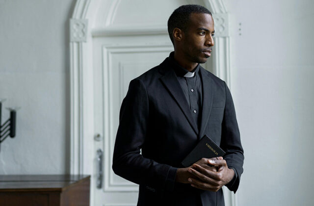 Pastor standing in a room contemplating his side hustle.
