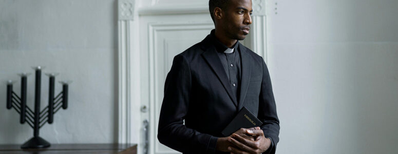 Pastor standing in a room contemplating his side hustle.