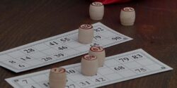 Bingo cards on a table with wooden stamps.