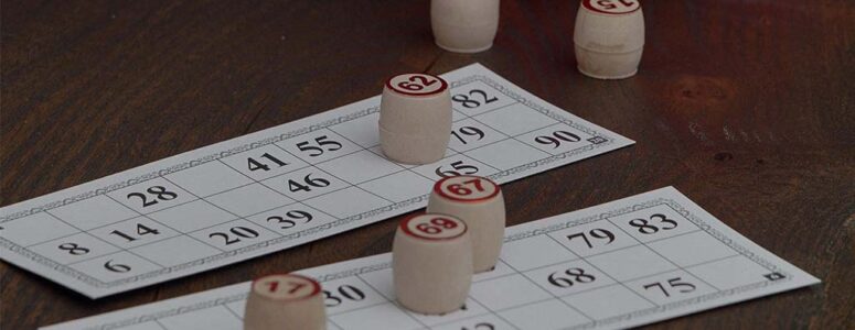 Bingo cards on a table with wooden stamps.