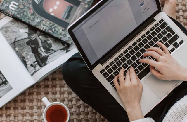 Close view of a freelance writer browsing a job board on their laptop.