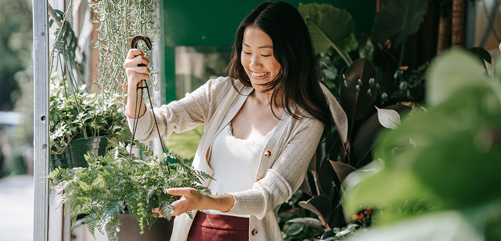a woman is helping her neighbor gardening