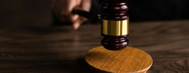 Close view of a gavel representing a legal proceeding that might be transcribed.