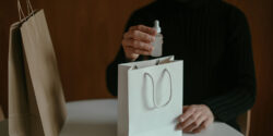 Close view of an Amazon product tester holding a bag with free products in it.