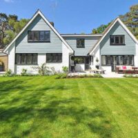 Suburban home with a well-maintained lawn, courtesy of someone's landscaping small business.