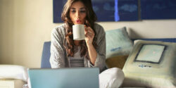 Woman sitting at her laptop using a microtask website to earn money.