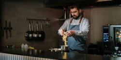 Personal chef in a home kitchen cooking noodles on a stovetop