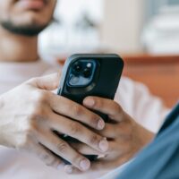 Man playing games for money for Scrambly on his phone.