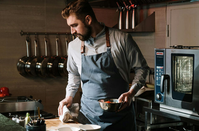 Chef in his kitchen working on his home-based cooking side hustle.