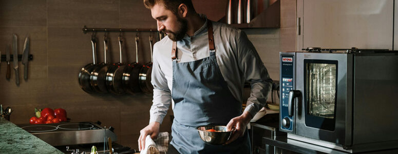 Chef in his kitchen working on his home-based cooking side hustle.