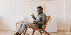 Person sitting in a chair and browsing work-on-demand job opportunities on a laptop