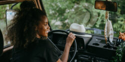Person smiling and driving a car