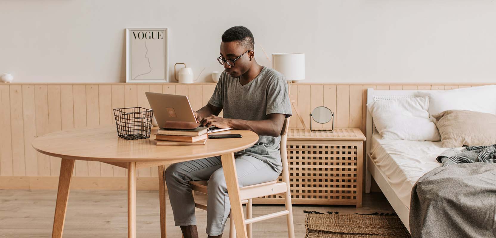 Freelance writer sitting at his desk AI tools on his laptop to write an assignment.