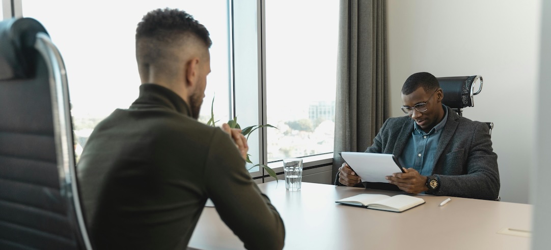 A hiring manager interviewing a job seeker.