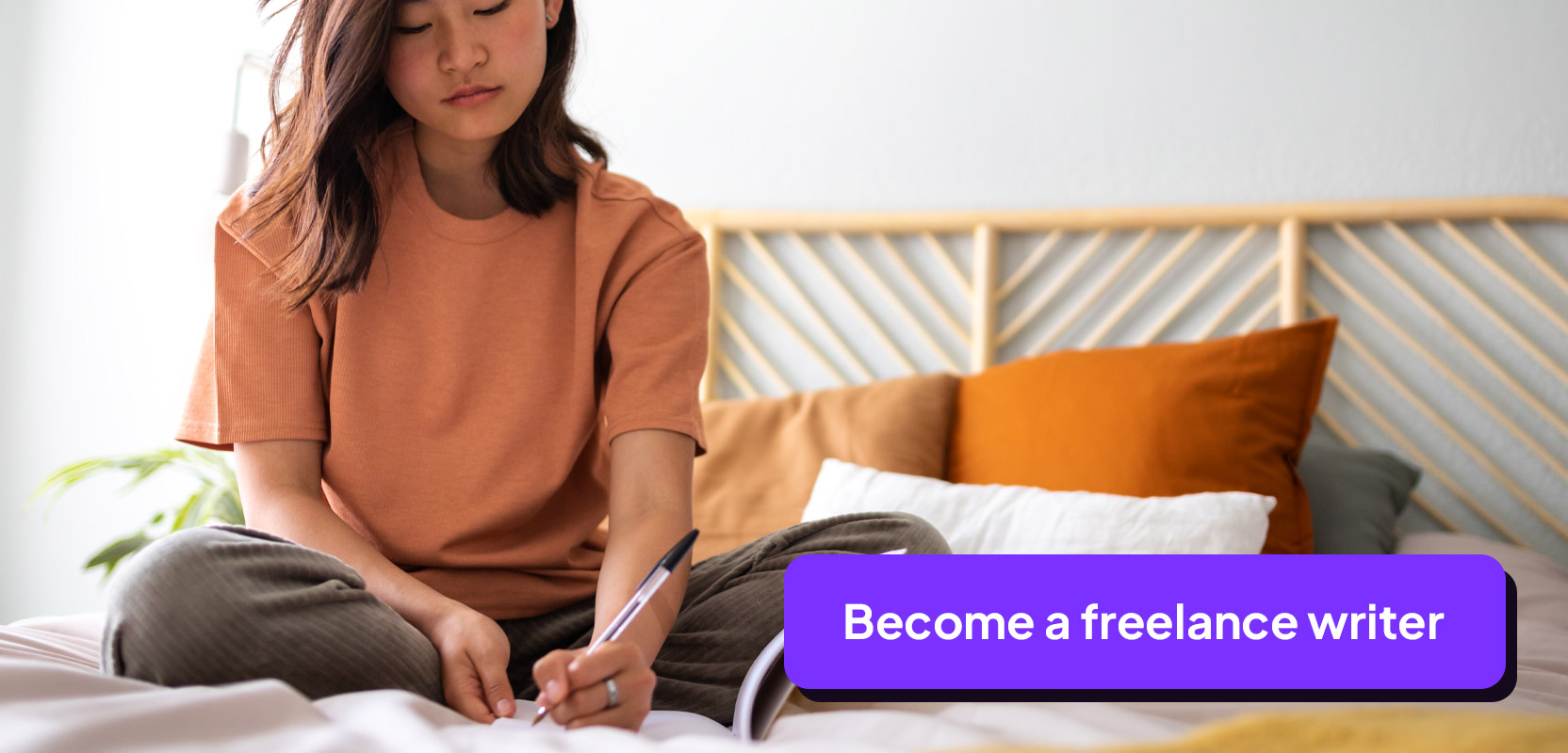 Teen sitting on her bed writing in a notebook as part of her freelance writing side hustle
