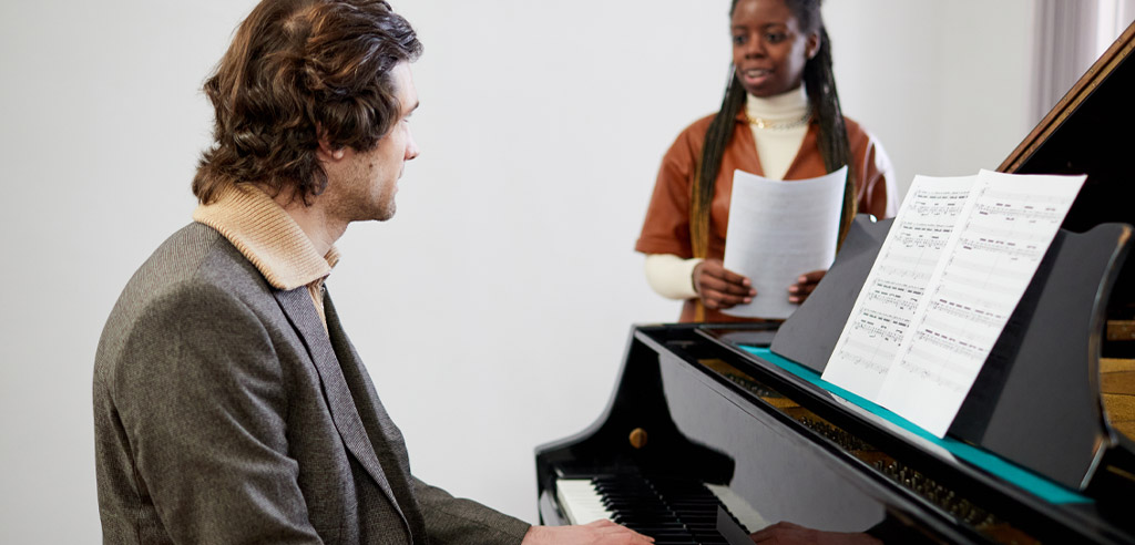 Musician sitting at a piano.