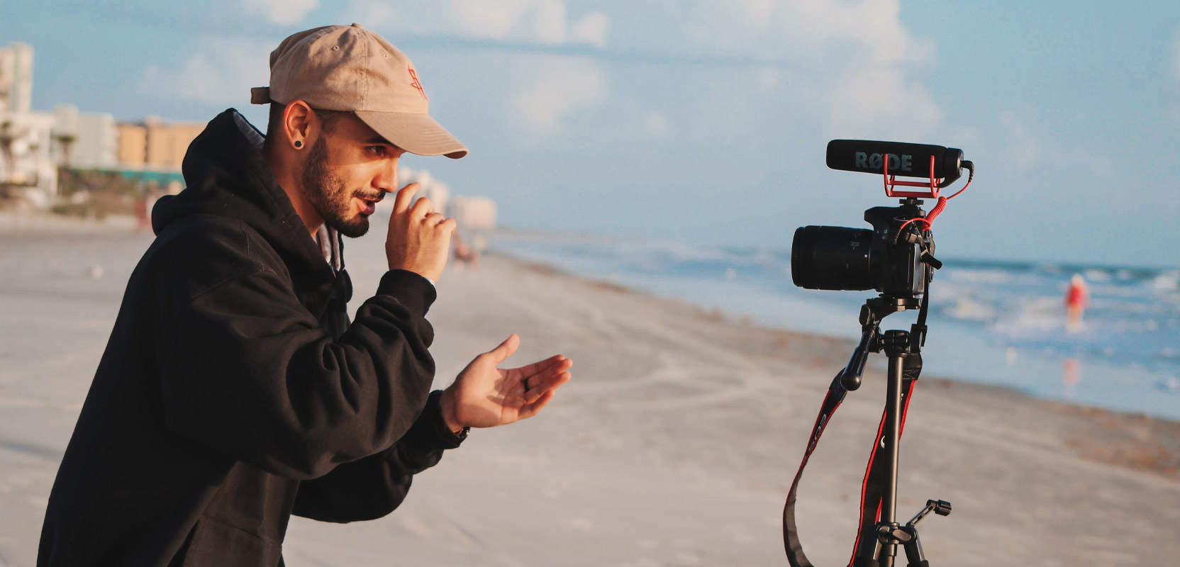 Photographer setting up a shot on the beach for his side hustle