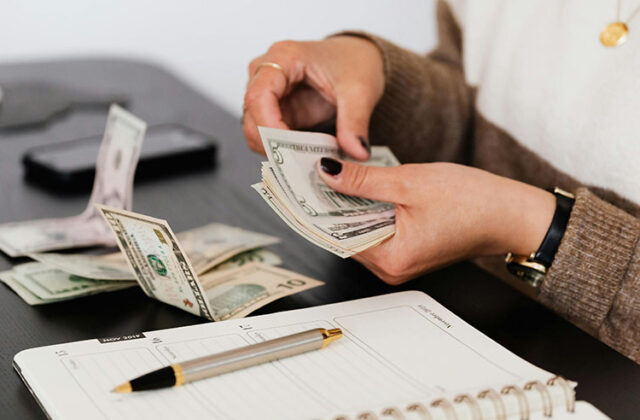 Freelance bookkeeper counting money.