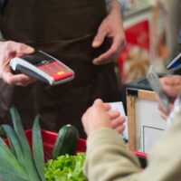 Customer receiving a receipt at a store before scanning it with CoinOut.