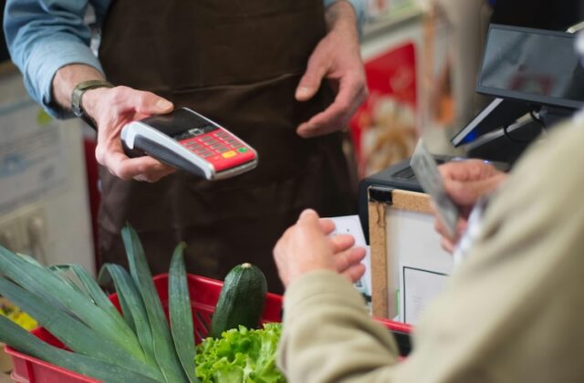 Customer receiving a receipt at a store before scanning it with CoinOut.