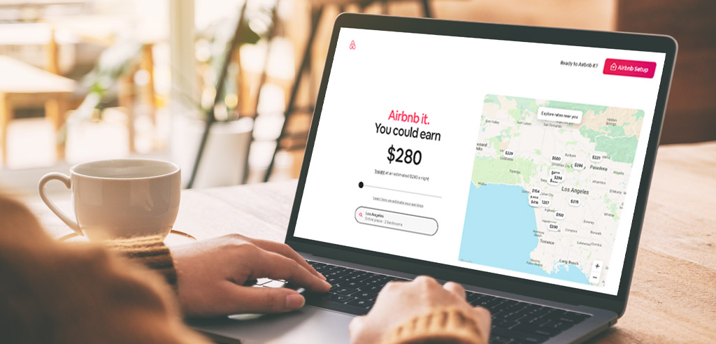 Close view of someone using a laptop with Airbnb.com open on the screen
