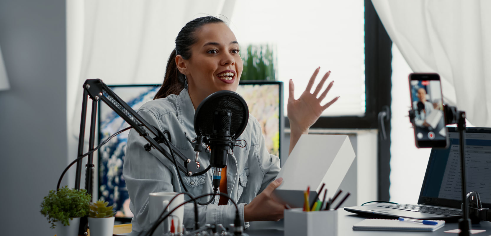 Female content creator speaking into a microphone while recording a podcast