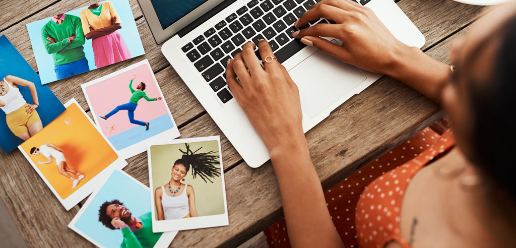 Writer sitting at a desk working on her blogging side hustle on her laptop