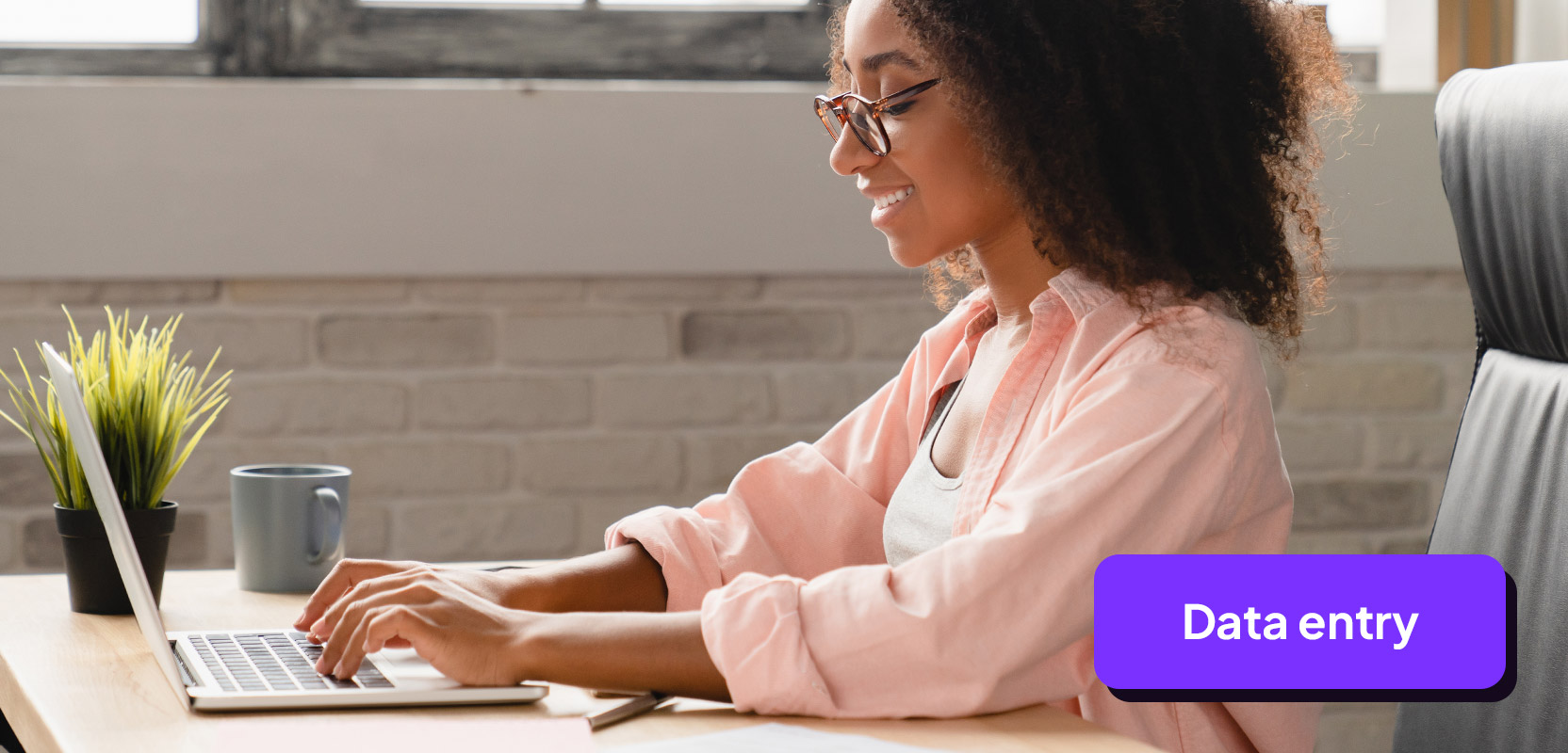 Woman sitting at a desk proofreading an article on her laptop