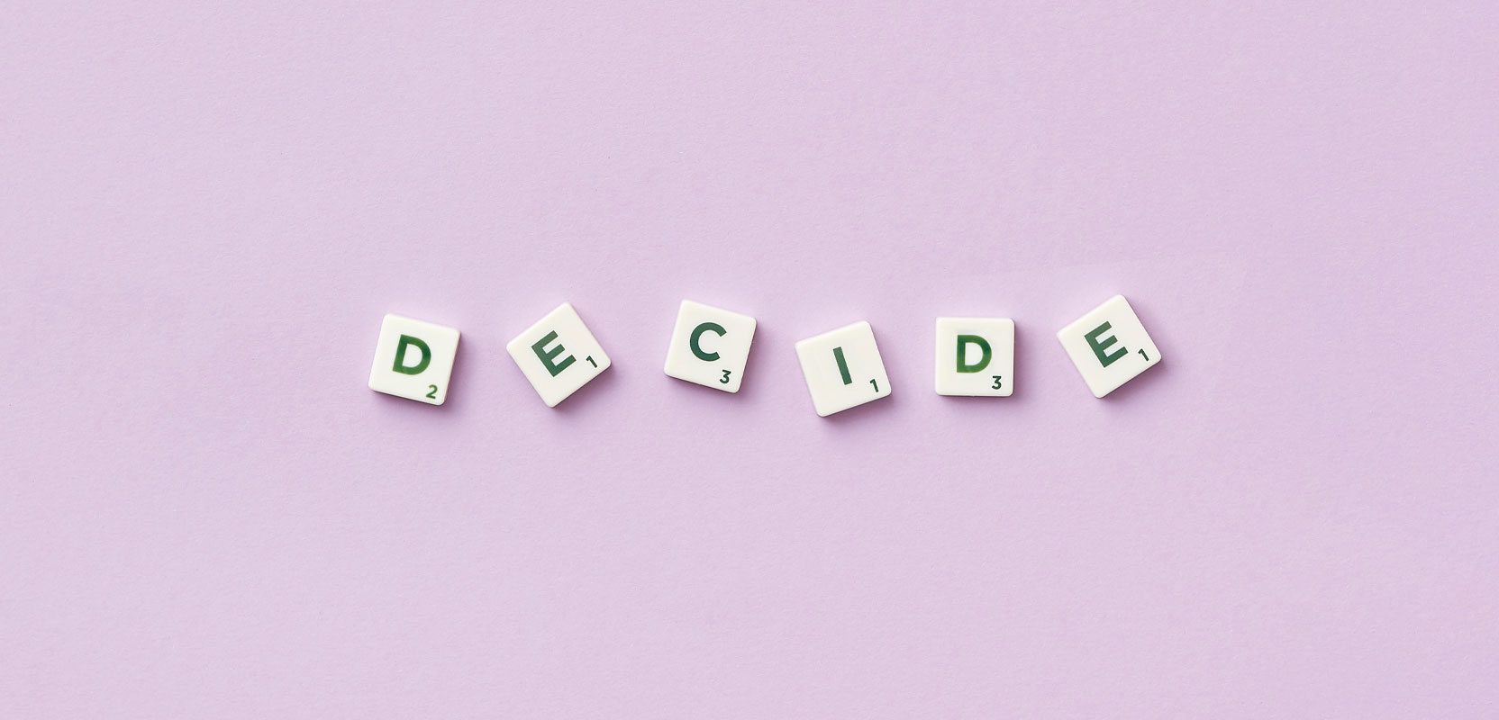Scrabble chips spelling out the word Decide