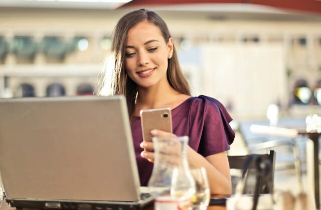 A digital nomad working from her laptop in a cafe.