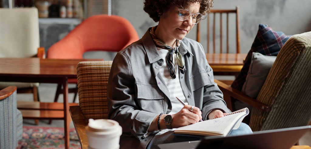 Woman quietly working on a writing side hustle