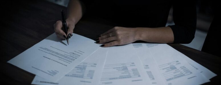 Close view of a freelance writer working on their taxes.