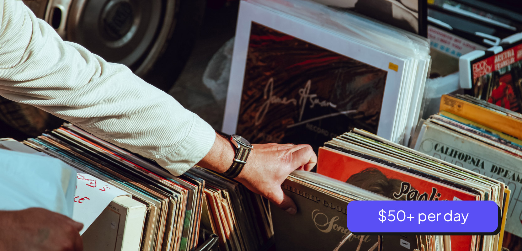 Man picking through old records at a garage sale 
