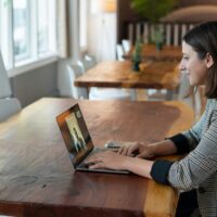 Virtual assistant chatting with a prospective client on her laptop.