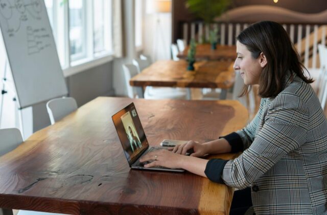 Virtual assistant chatting with a prospective client on her laptop.