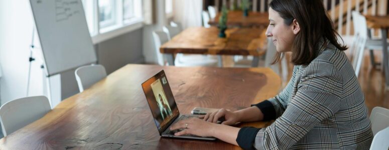 Virtual assistant chatting with a prospective client on her laptop.