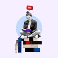 Freelance worker sitting and looking at an open book that she's getting paid to read