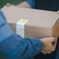 Gopuff delivery driver handing over a package.