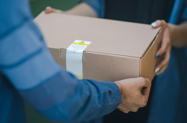 Gopuff delivery driver handing over a package.