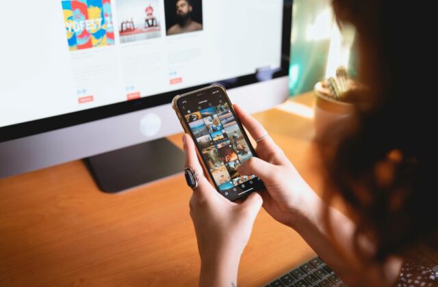 A hiring manager reviewing a job applicant's photos posted on their personal social media account.