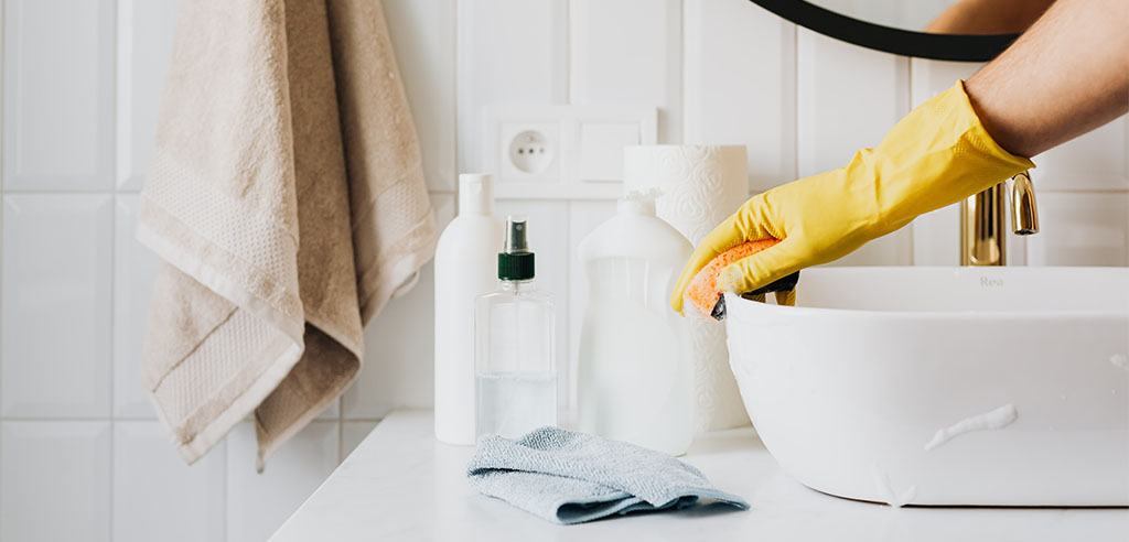 a house cleaner is cleaning the toilet