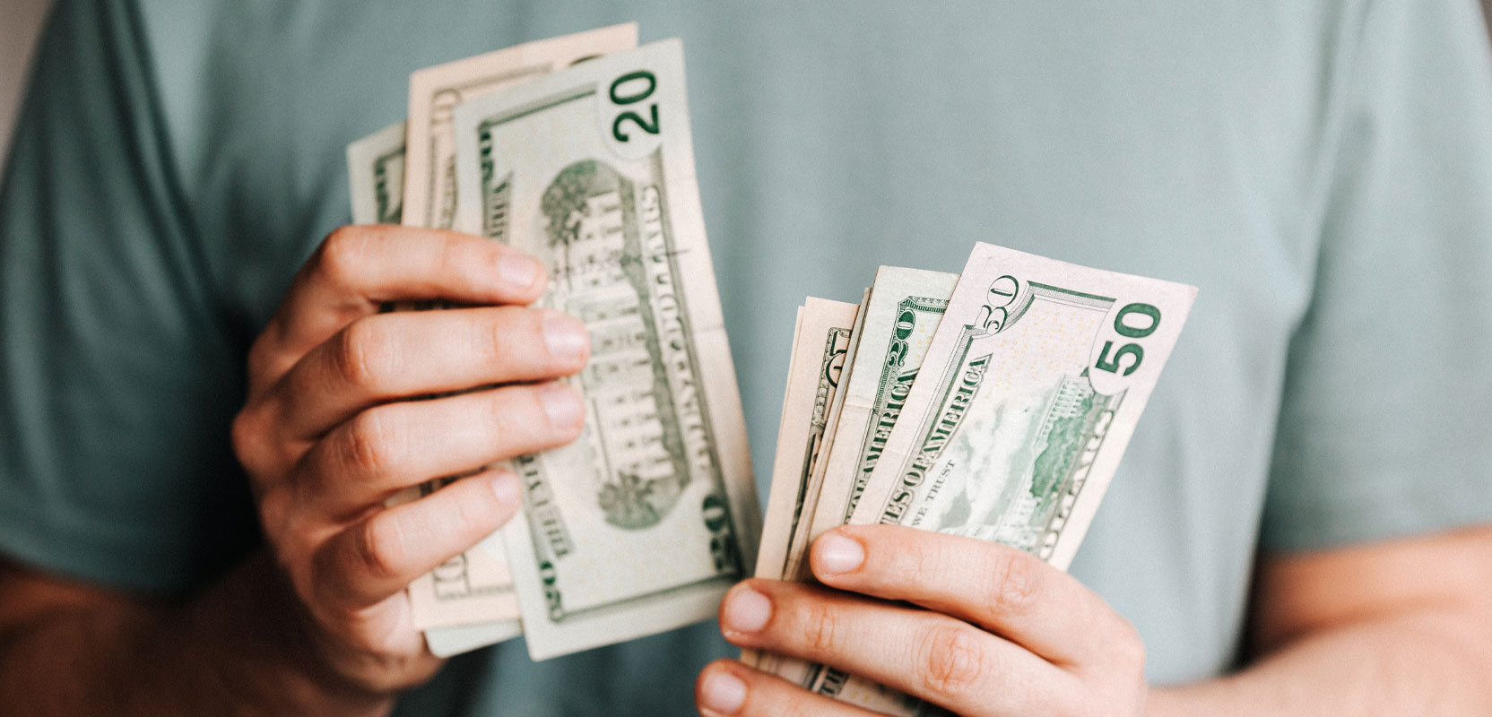Closeup of person holding a large amount of cash