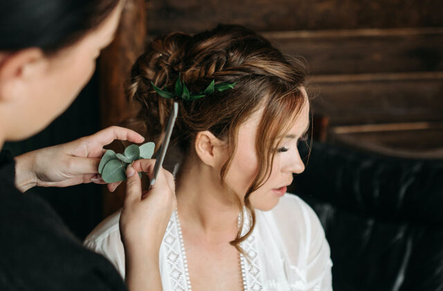 Professional hairstylist arranging an updo for a hair client